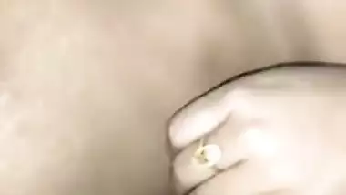 Desi lies on her back but sex partner touches her XXX breasts on camera