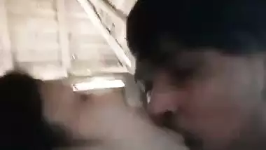 A guy presses a girl’s boobs outdoors in the local sex video